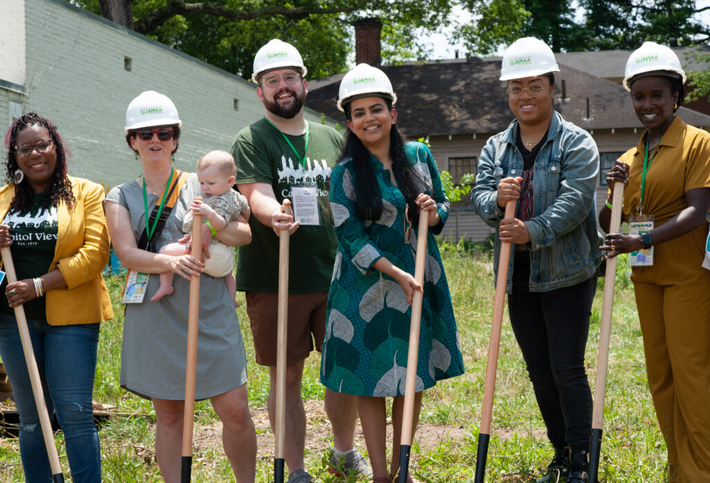 Community members and the Guild team at the groundbreaking for 918 Dill Ave, wearing hard hats and holding shovels